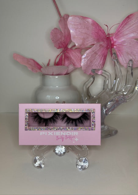 Lunaria celestial lashes displayed with pink accents in a stylish holder, showcasing luxury real mink for an ethereal look.