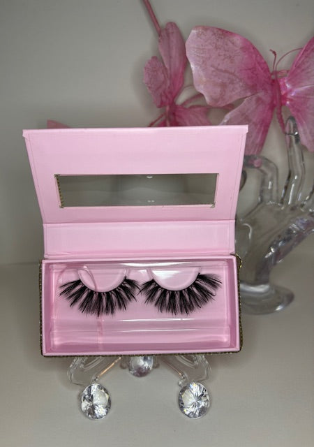 Roux lash set in luxe pink packaging with bold lashes, showcasing sultry design and refined elegance.